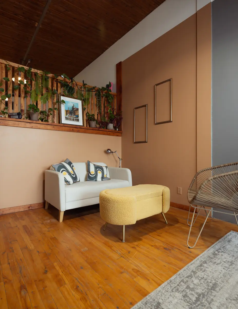 Décor mur ocre avec canapé au Studio Popcorn